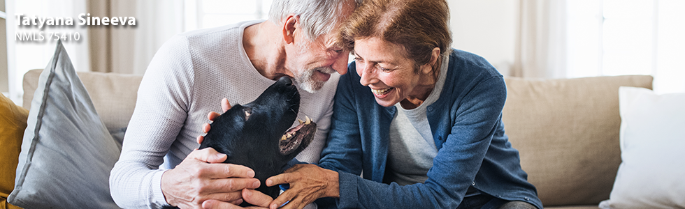 Couple on the sofa petting their dog